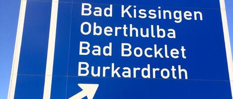 A directional road sign with destinations listed.