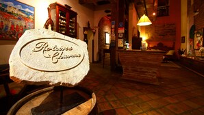A rustic interior with a sign reading "Restaurant & Bar" and a wooden barrel. - Pousada do Amparo (Olinda)