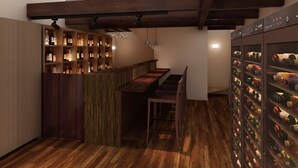 A modern kitchen with wooden beams, a bar area with bottles, and a wine fridge. - CHIKUYOAN (Nagaokakyo)
