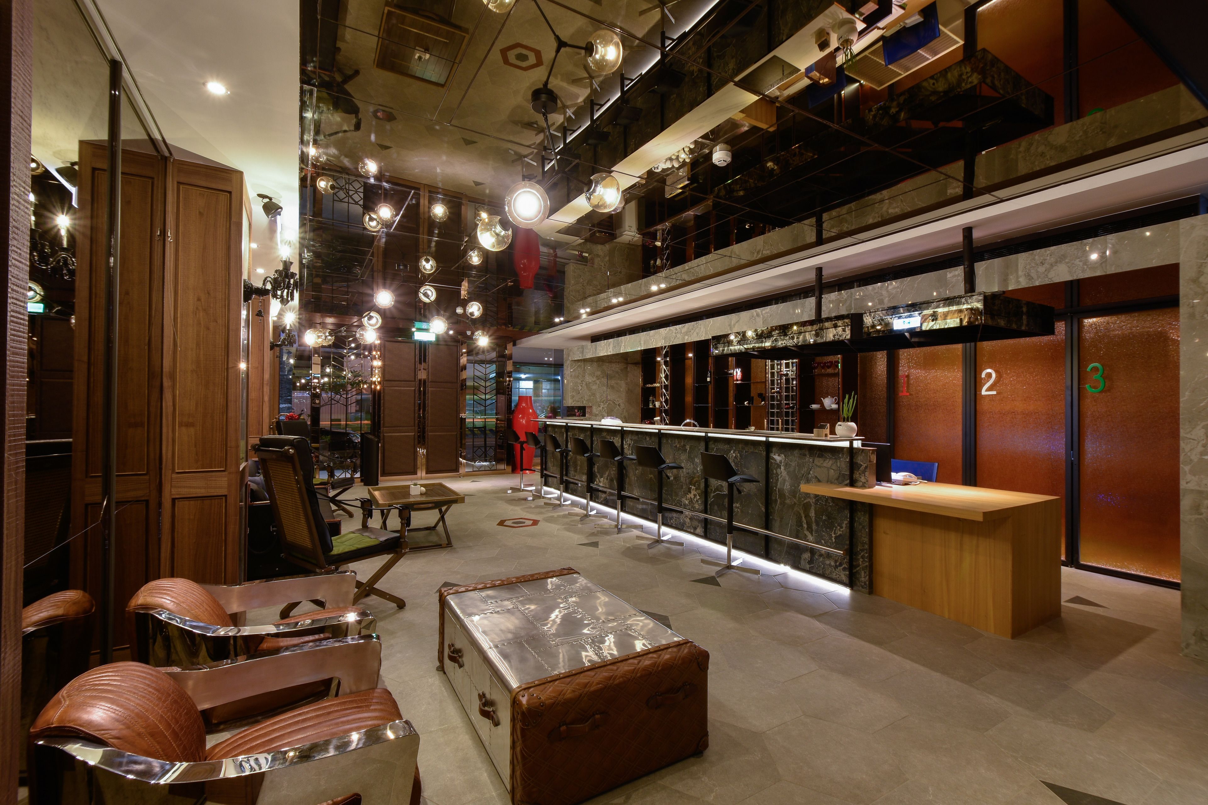 A spacious lobby with a reception desk, seating area, and a bar.