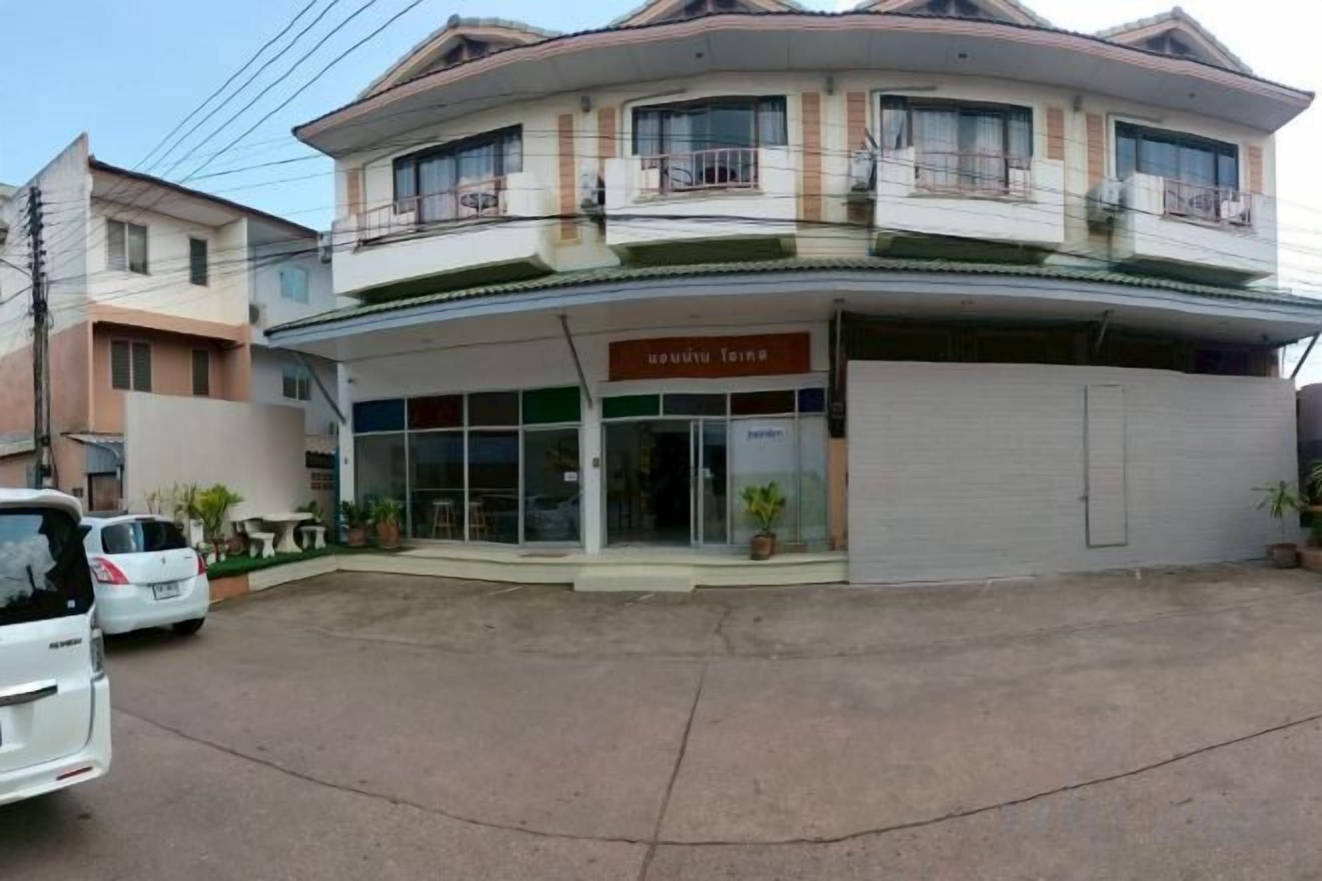 A two-story building with a ground-level commercial space and a residential upper floor.
