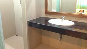 A bathroom with a black countertop, a white sink, and a mirror. - Lankham Hotel (Pakse)