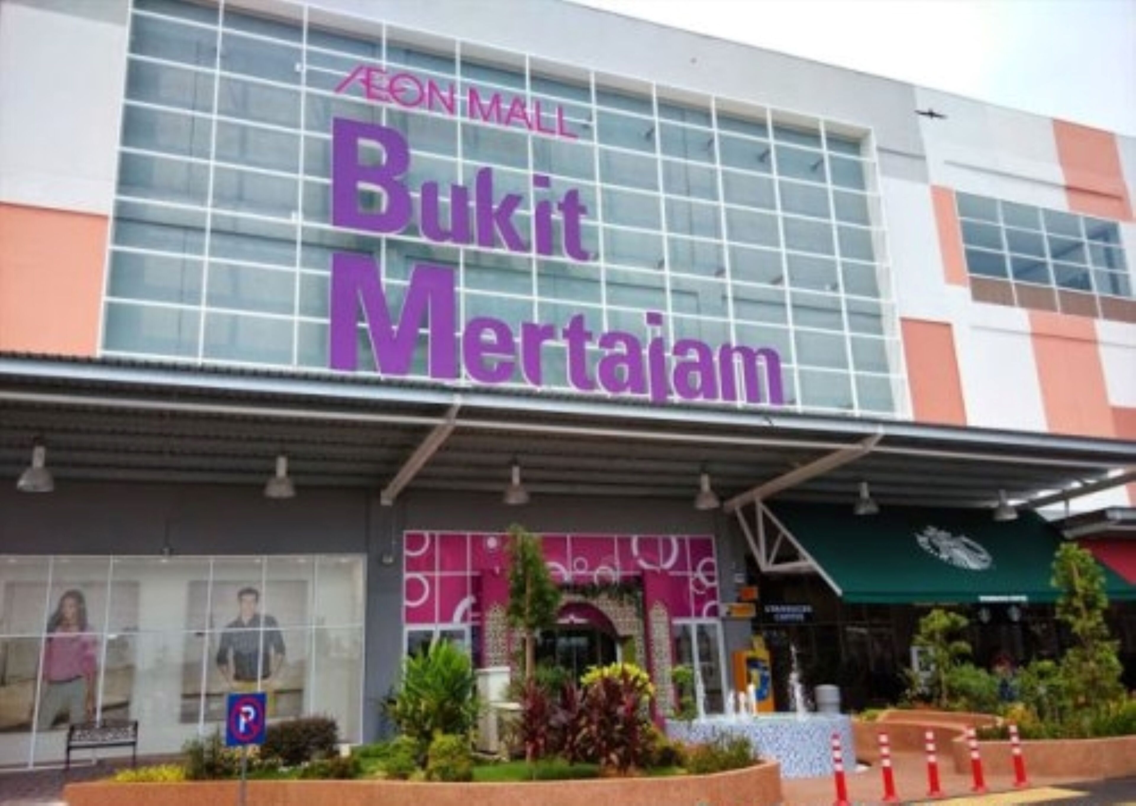 A shopping mall with a large sign for 'Bukit Mertajam' at the entrance.