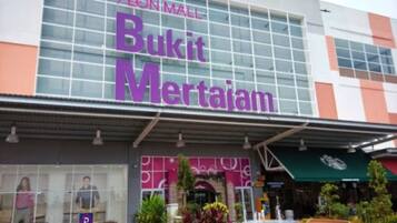 A shopping mall with a large sign for 'Bukit Mertajam' at the entrance.