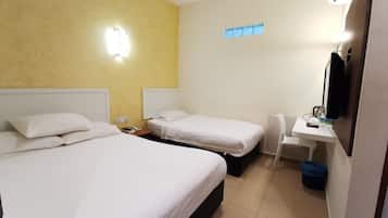 A hotel room with two beds, a desk, a chair, a telephone, and a television.