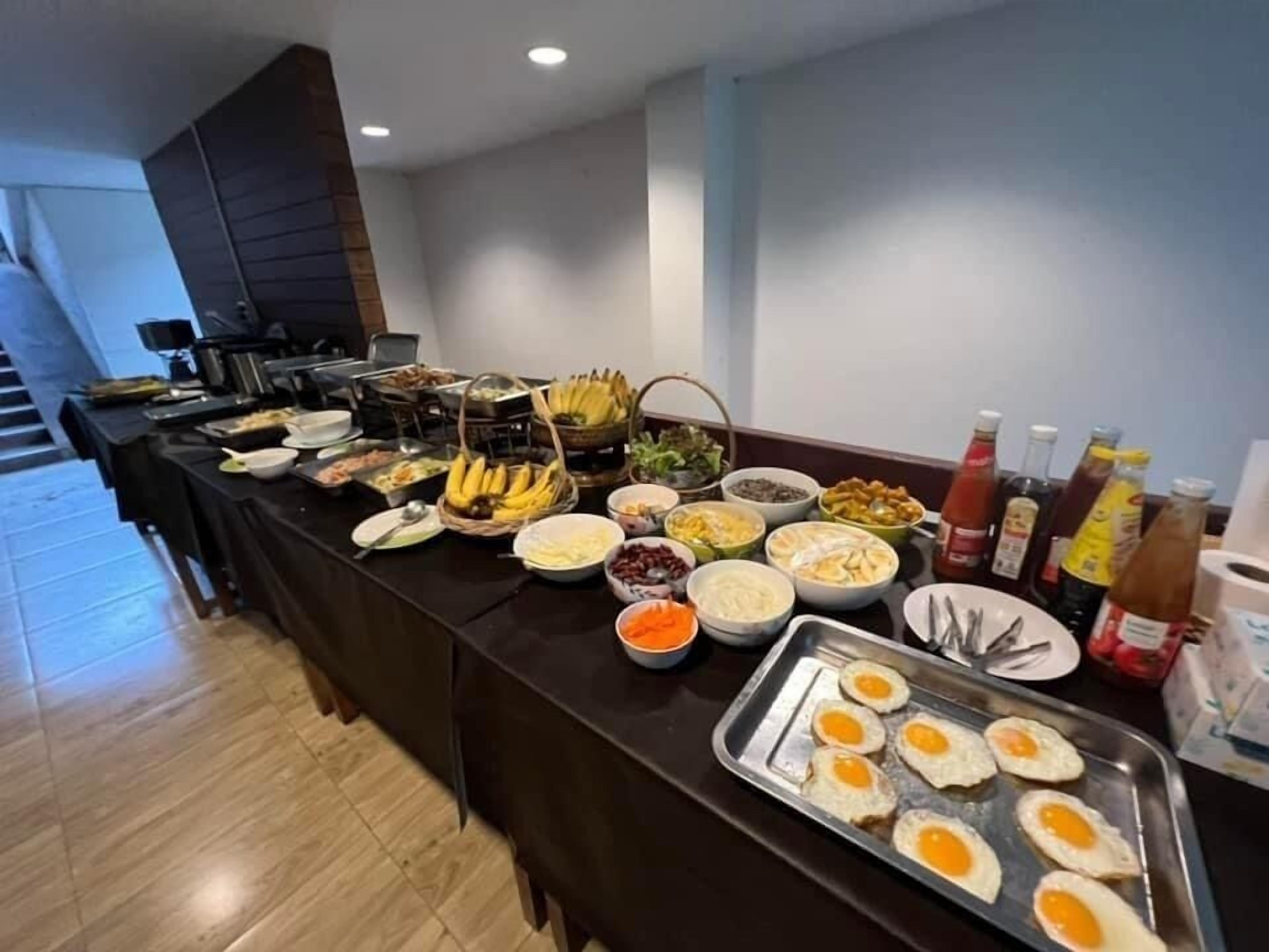 A buffet with various food items and condiments.