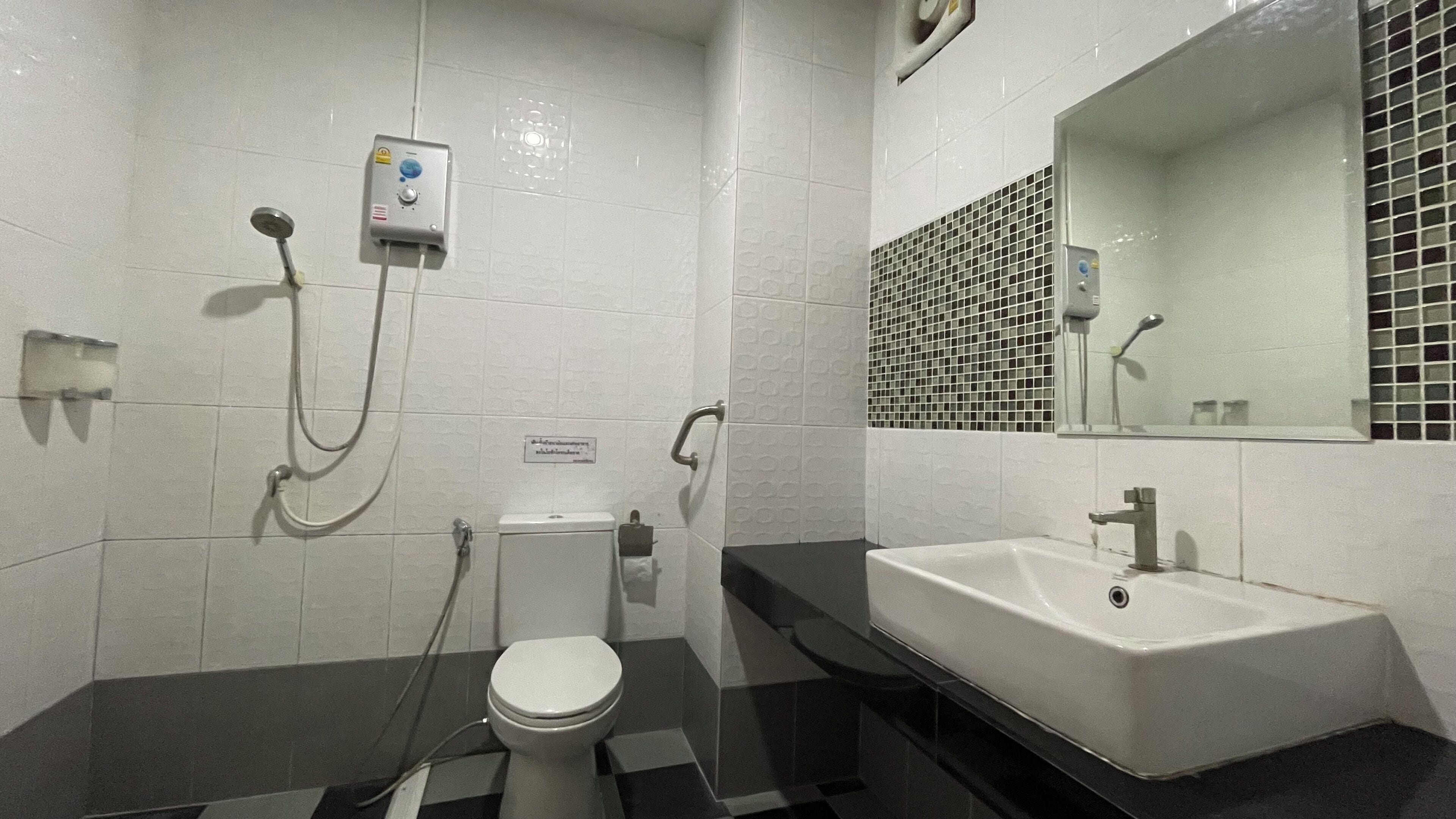 A modern bathroom with a toilet, bidet, and sink.