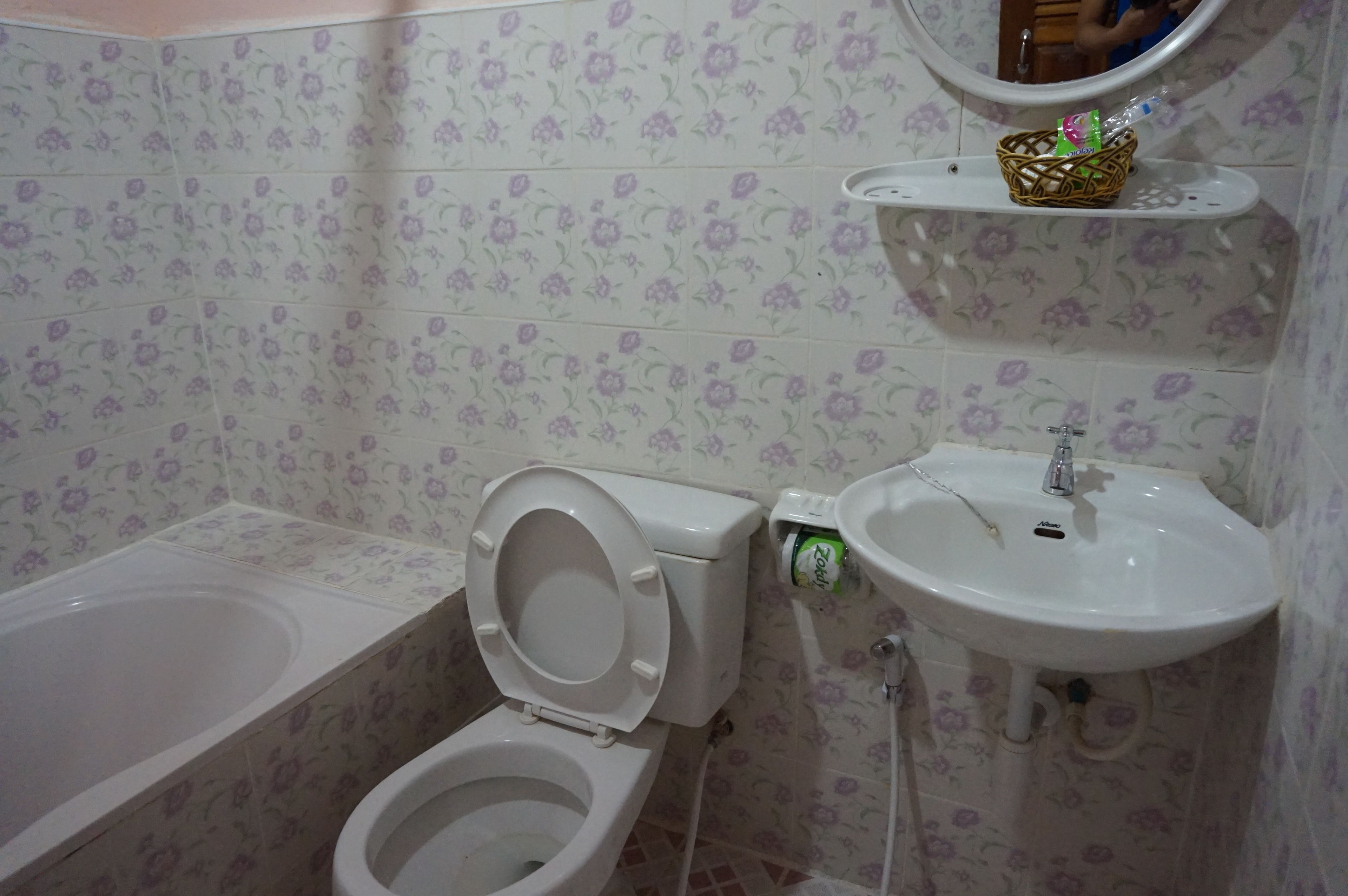 A bathroom with a toilet, sink, and bathtub.