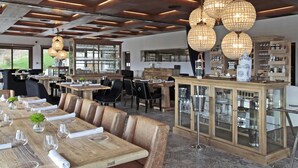 A restaurant with wooden tables, leather chairs, and hanging crystal chandeliers. - Puebloastur Eco-Resort Wellness & Spa (Parres)