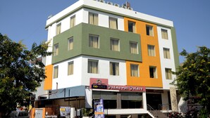 A multi-story hotel with a reception area, a staircase, and a signboard. - FabHotel Padmavati Palace Mansarovar (Jaipur)