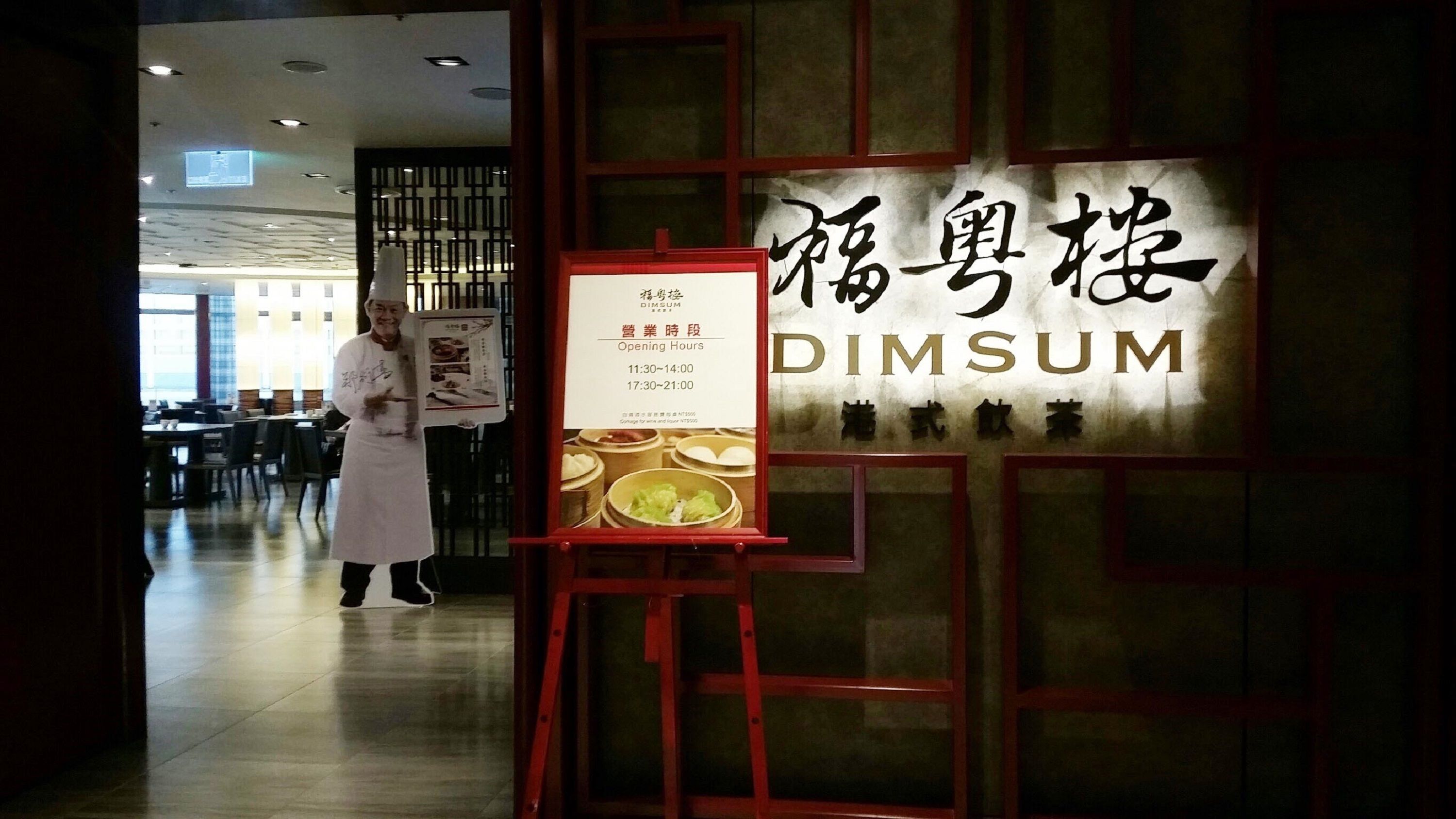 A restaurant interior with a sign reading "DIMSUM" and a menu board.