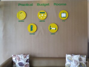 A wall with labeled icons for amenities: shower, air conditioning, TV, room, and bed. - GV Hotel Tagbilaran (Tagbilaran)