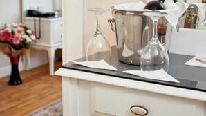 A white vanity with a mirror, a champagne bucket, and a wine glass on a black countertop. - Mataraci Konak (Istanbul)