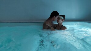 A couple in a hot tub with a plain wall in the background. - Tinos Aqua Palazzo (Tinos)