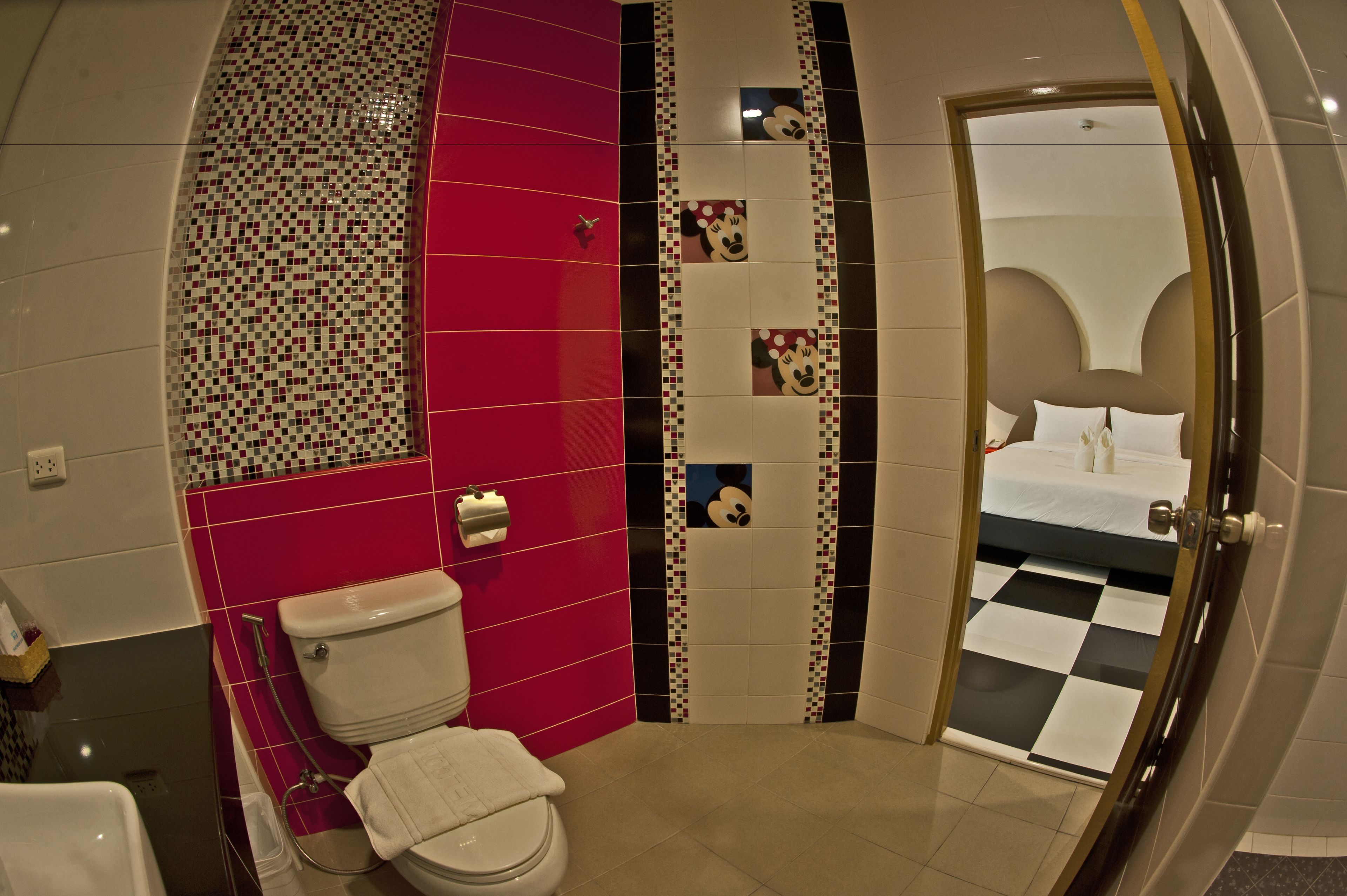 A bathroom with a toilet, a sink, and a shower area.