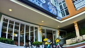 A modern building with a sign reading "OMG PLACE". - OMG Hotel (Khon Kaen)