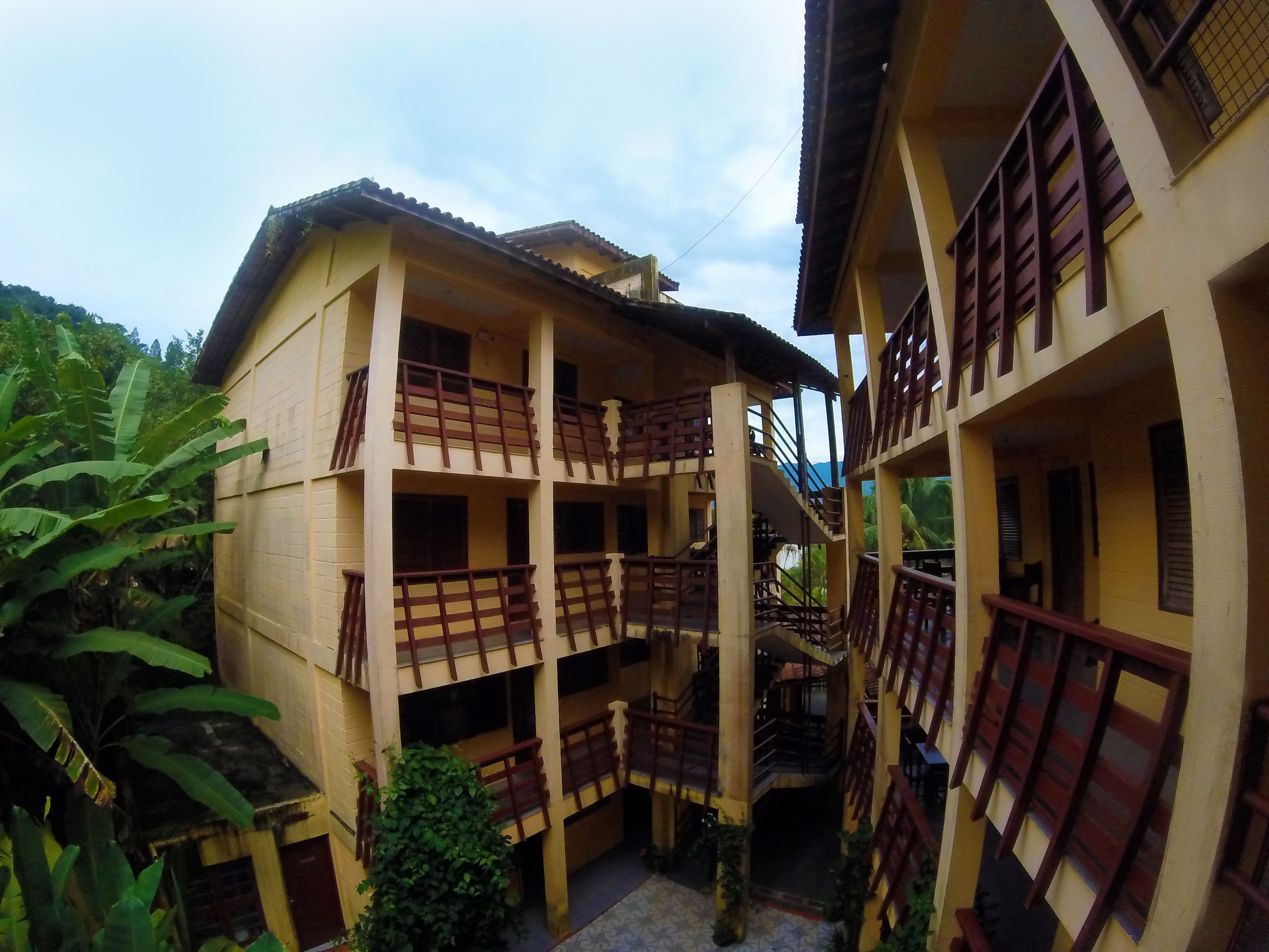 A multi-story building with balconies and staircases.