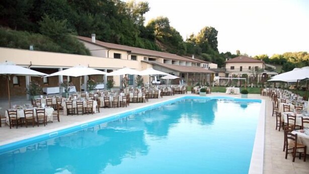 Seasonal outdoor pool, open 9 AM to 7 PM, pool umbrellas, pool loungers
