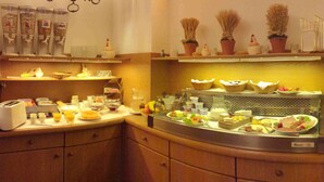 A breakfast buffet with various food items and condiments. - Hotel Wurms (Düsseldorf)