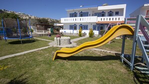 A playground with a yellow slide and a blue swing set. - Villa Bel Passo (Kos)