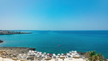 Private beach, black sand, free beach shuttle, sun loungers