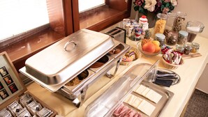 A buffet setup with various food items and condiments. - Tavel Boutique Hotel (Prešov)