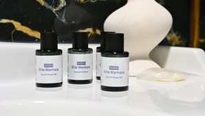 Three bottles of Elite Marmara products on a white sink with a marble background. - Elite Marmara Hotel Gungoren (Istanbul)
