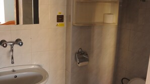 Un baño con lavabo, inodoro y espejo.