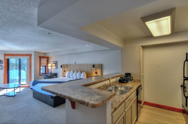 Studio Condo | Individually decorated, desk, laptop workspace, blackout curtains