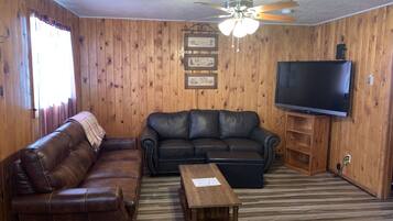 Deluxe Cabin, 2 Bedrooms, Mountain View | Living area | 50-inch TV with satellite channels