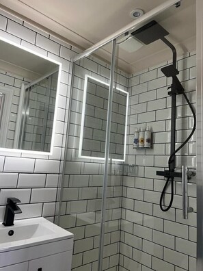 Shower, designer toiletries, hair dryer, towels