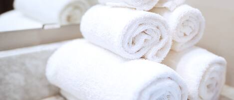 A stack of neatly rolled white towels.