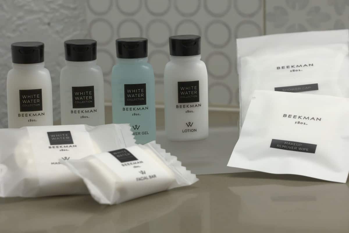 A collection of skincare products from the Beekman brand, including a facial bar, lotion, and a remover wipe.