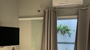 A modern bathroom with a shower, a toilet, and a sink.