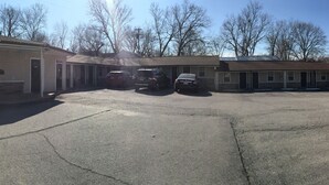 A row of single-story mobile homes with a parking area in front.