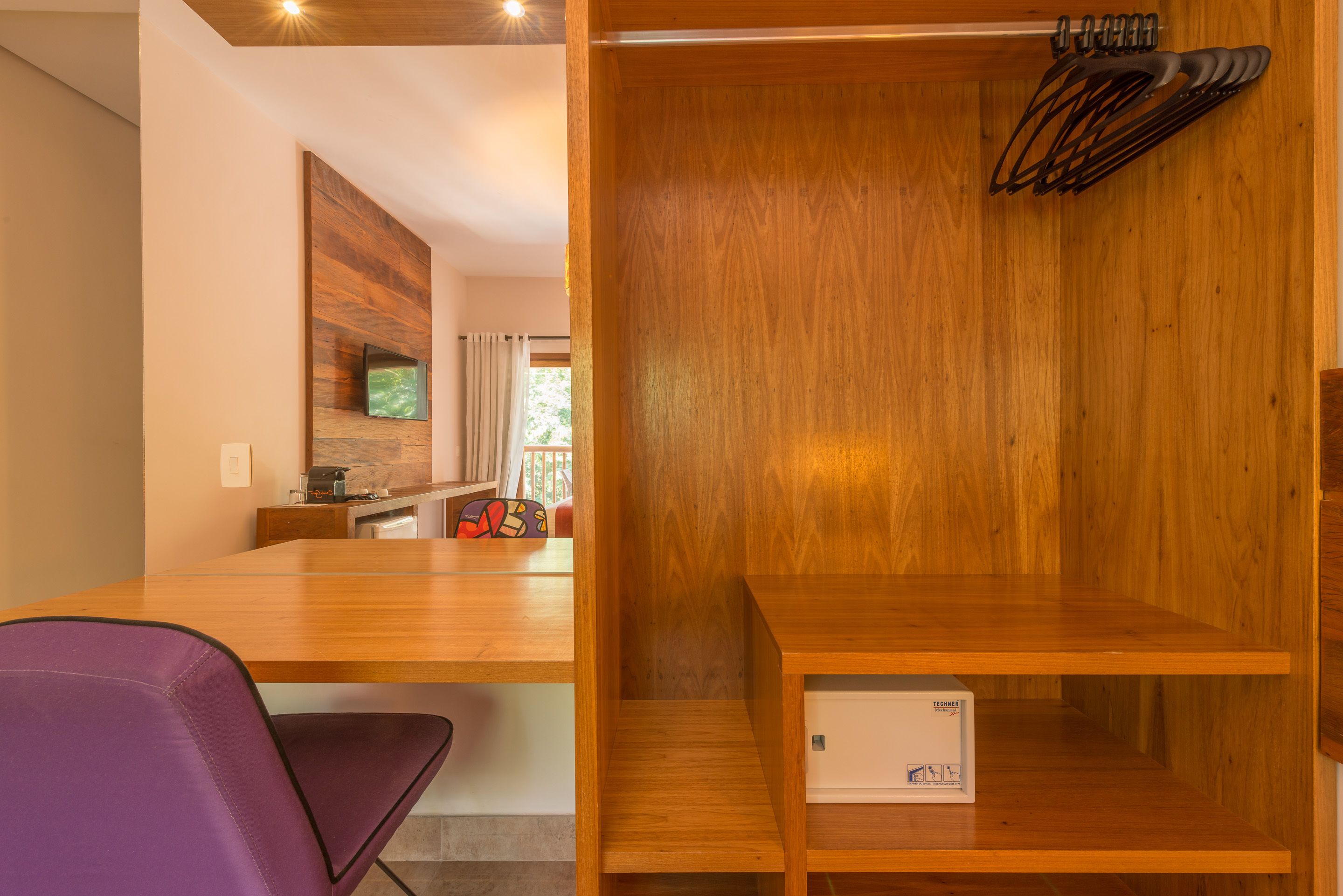 A modern kitchen with wooden cabinetry, a built-in microwave, and a small island with a sink.