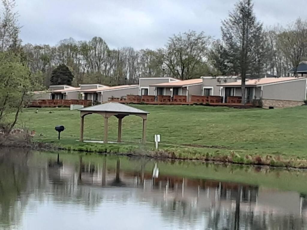 A residential area with houses, a pond, and a gazebo.