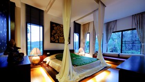 A bedroom with a canopy bed, large windows, and a view of the outdoors. - Chiangmai Highlands Golf and Spa Resort (Mae On)
