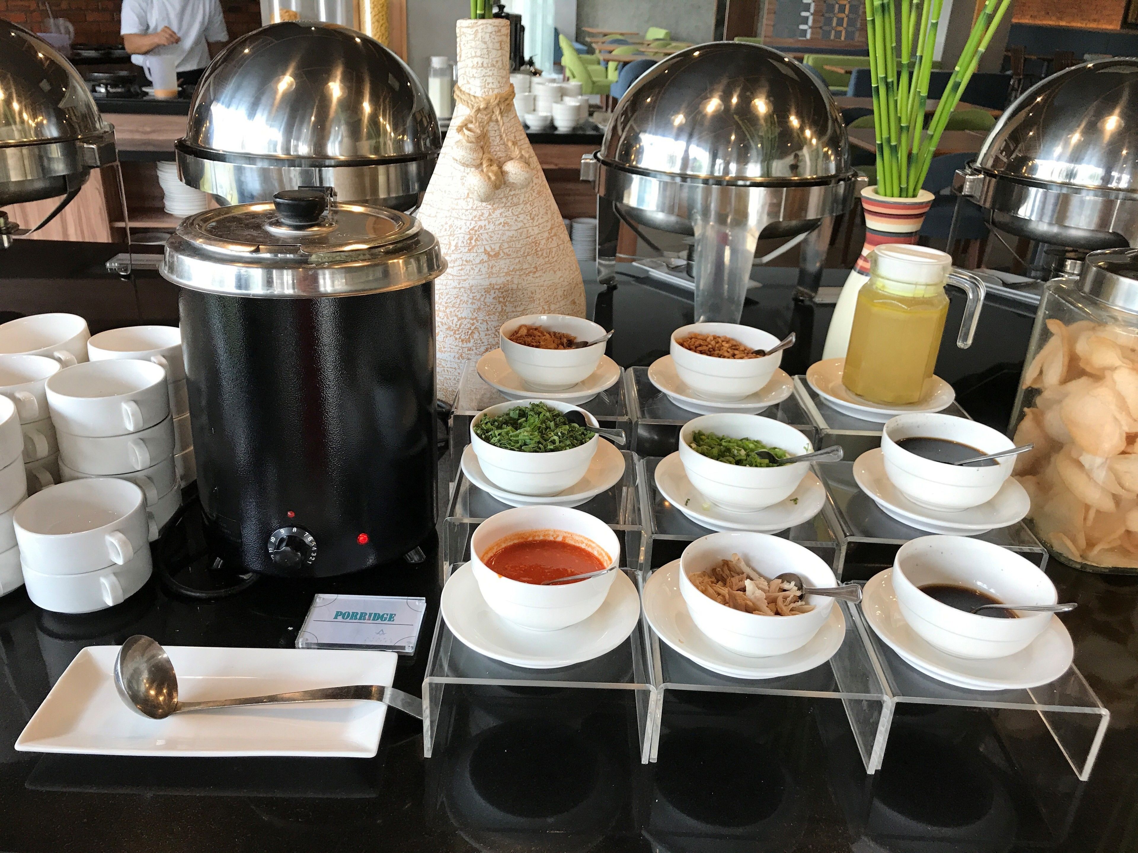 A buffet setup with various food items and condiments.