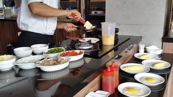 A buffet setup with various food items and condiments.