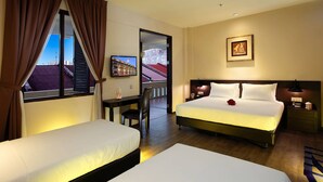 A hotel room with two beds, a desk, a chair, a television, and a framed picture on the wall. - Kimberley Hotel Georgetown (George Town)