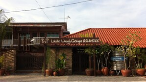 A building with a sign reading "Little Woody Cottage." - TnT Novelty House (Teluk Intan)