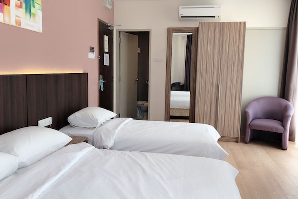 Deluxe Triple Room | Minibar, in-room safe, desk, iron/ironing board
