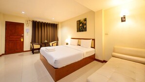 A hotel room with a large bed, a bedside table, a chair, and a wall-mounted lamp. - Nuntiya Terrace (Udon Thani)