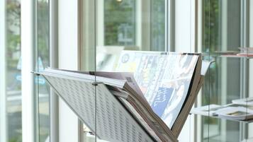 A glass display case with newspapers and magazines.