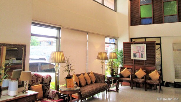 A spacious lobby with high ceilings, large windows, and a variety of seating arrangements including sofas and chairs. - Maxandrea Hotel (Cagayan de Oro)