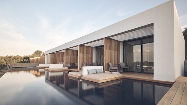 A modern outdoor pool area with a minimalist design, featuring a long bench and seating arrangements. - Zante Maris Suites - Adults Only (Zakynthos)