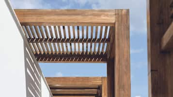 A wooden pergola structure against a clear sky.