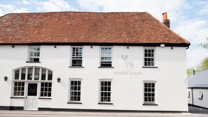 A white building with a tiled roof, named "The White Hart."