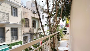 A narrow balcony with a white railing, a small table, and a chair. - Live in Athens, Psyrri Central Apartments (Athens)